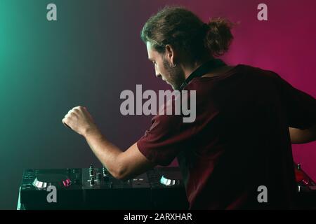 Male dj playing music in nightclub Stock Photo