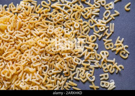 Heap of dry pasta on dark background Stock Photo