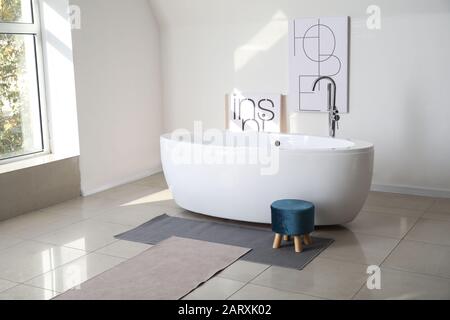 Modern ceramic bathtub in light interior Stock Photo