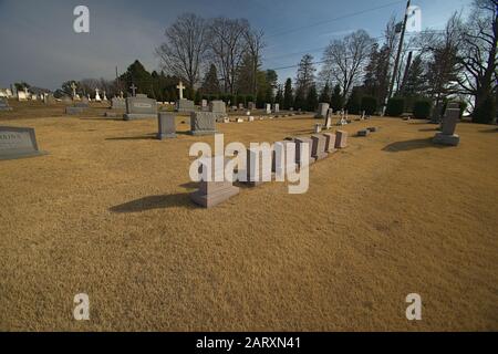 graveyard in winter with dormant grass Stock Photo