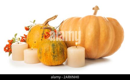 Beautiful autumn composition with pumpkins and candles on white background Stock Photo