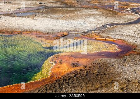 Abyss pool in Yellowstone of vivid colors caused by thermophilic bacteria Stock Photo