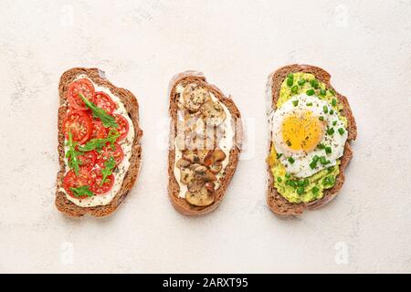 Tasty sandwiches on light background Stock Photo