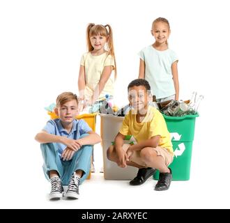 Little children and containers with trash on white background. Concept of recycling Stock Photo