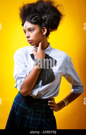 Young smart girl portrait on a yellow background Stock Photo