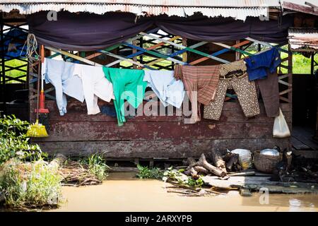 Laundry on a wooden floating house in poor village at Tonle Sap Lake in Puok, Siem Reap Province, Cambodia Stock Photo