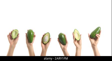 Female hands with fresh avocados on white background Stock Photo