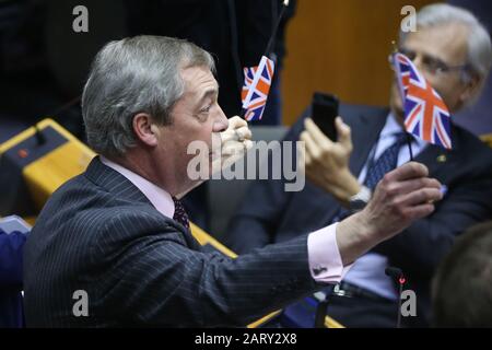 Brussels, Belgium. 29th Jan, 2020. Member of the European Parliament and Brexit Party Leader Nigel Farage waves a British flag at the plenary session of the European Parliament in Brussels, Belgium, on Jan. 29, 2020. The European Parliament voted overwhelmingly on Wednesday to approve the Withdrawal Agreement between the European Union (EU) and the United Kingdom. Credit: Zheng Huansong/Xinhua/Alamy Live News Stock Photo