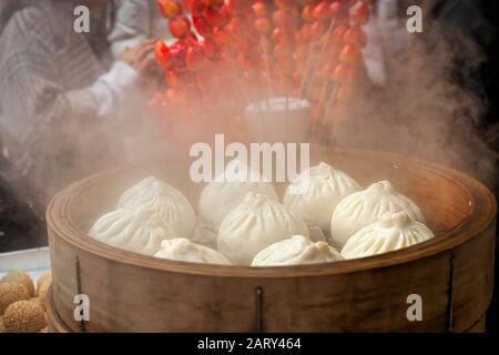 Asian dumplings, called dim sum, cooking in a wooden steamer in Yokohama Japan's Chinatown near Tokyo. Stock Photo