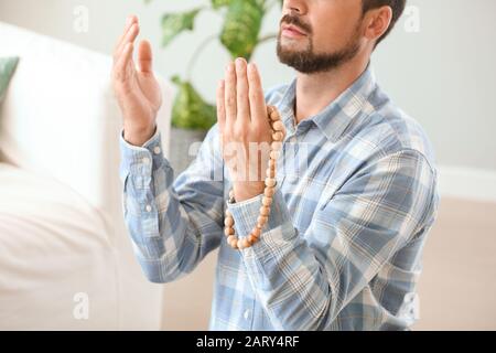 Muslim man praying at home Stock Photo