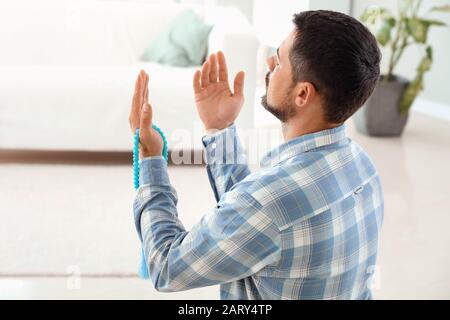 Muslim man praying at home Stock Photo