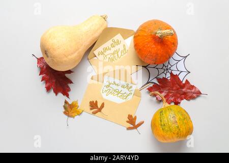 Invitations with envelopes and autumn decor on white background Stock Photo