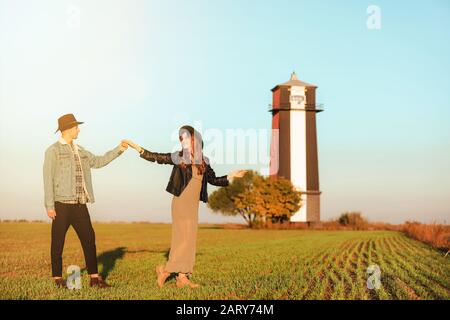 Happy young couple dancing in countryside Stock Photo