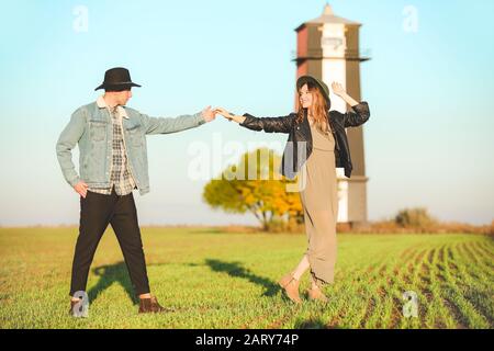 Happy young couple dancing in countryside Stock Photo