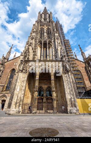 Ulm Minster or Cathedral of Ulm city, Germany. It is a top landmark of Ulm. Front view of ornate entrance of old Gothic church in summer. Facade of fa Stock Photo