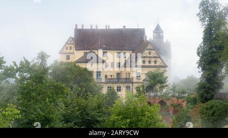 Castle of Heiligenberg in mist, Linzgau, Germany. This Renaissance castle is a landmark of Baden-Wurttemberg. Scenic view of mystery castle in foggy g Stock Photo