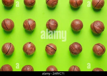 Tasty macadamia nuts on color background Stock Photo