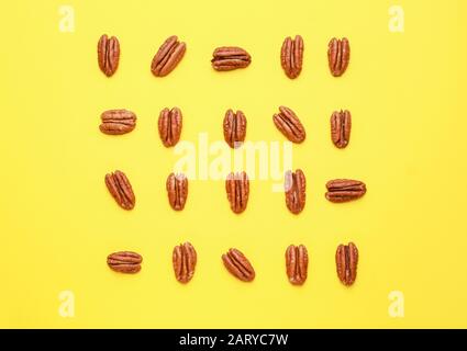 Tasty pecan nuts on color background Stock Photo