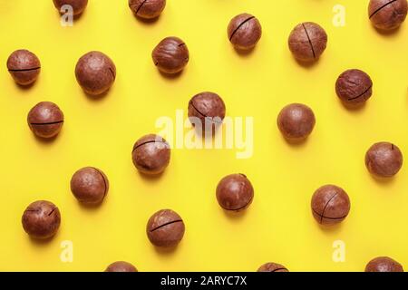 Tasty macadamia nuts on color background Stock Photo