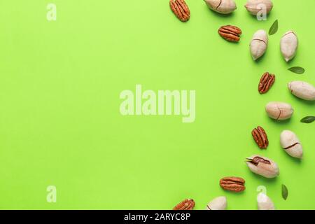 Tasty pecan nuts on color background Stock Photo