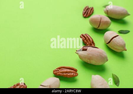 Tasty pecan nuts on color background Stock Photo