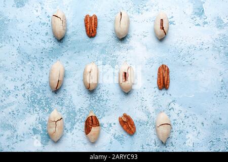 Tasty pecan nuts on color background Stock Photo