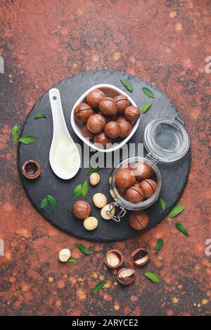 Tasty macadamia nuts on color background Stock Photo