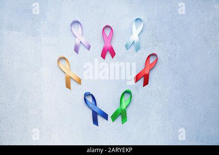 Different awareness ribbons on color background Stock Photo