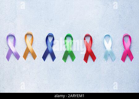 Different awareness ribbons on color background Stock Photo