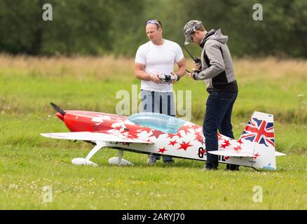 Two men with a radio controlled model aircraft Stock Photo