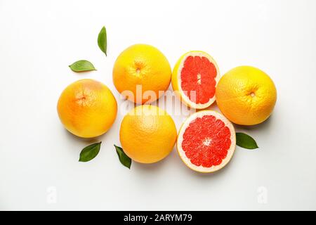 Fresh ripe grapefruits on light background Stock Photo