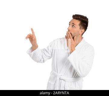 Surprised man in bathrobe pointing at something on white background Stock Photo