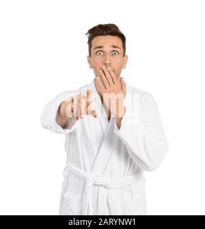 Surprised man in bathrobe pointing at viewer on white background Stock Photo