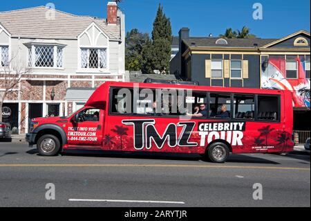 TMZ Celebrity Tour bus with tourists on the Sunset Strip in Los Angeles