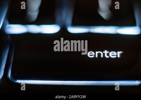 Illuminated 'enter' key on keyboard Stock Photo