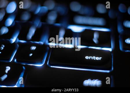 Illuminated 'enter' key on keyboard Stock Photo