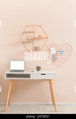 Modern comfortable workplace near color wall Stock Photo
