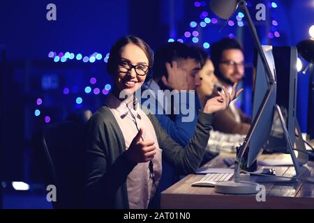 Technical support agents working in office at night Stock Photo