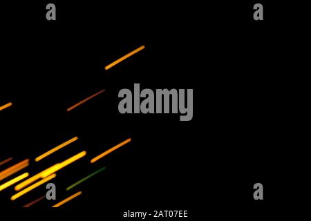 Futuristic blurred lights holiday monochrome background in saturated yellow gold and black, perfect for Christmas, New Year, Valentine, party, technology drop. Horizontal, soft focus Stock Photo