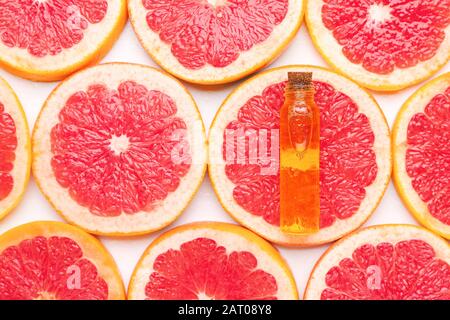 Bottle of essential oil on grapefruit slices Stock Photo