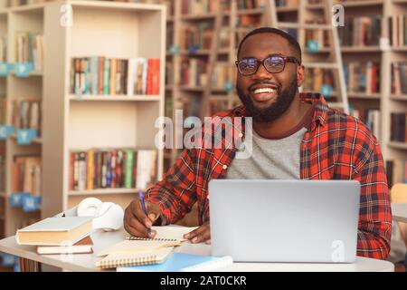 African-American student preparing for exam in library Stock Photo
