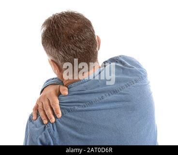 Mature man suffering from shoulder and back pain while sitting on chair ...