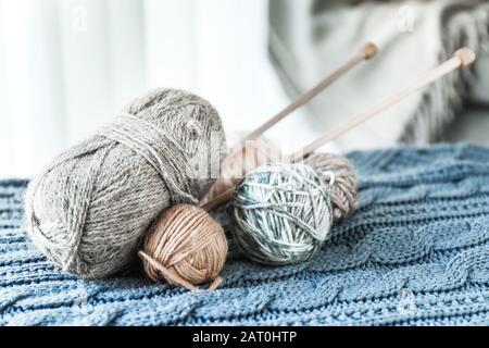 Knitting yarn and needles on plaid at home Stock Photo
