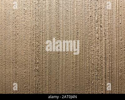 texture of grainy plastered interior wall. bronze striped plaster background Stock Photo