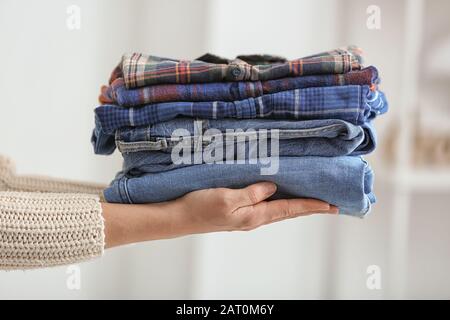 Woman with stack of clean clothes, closeup Stock Photo