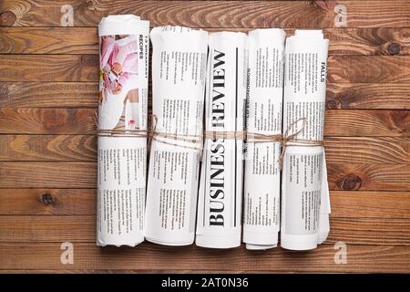 Many newspapers on wooden background Stock Photo