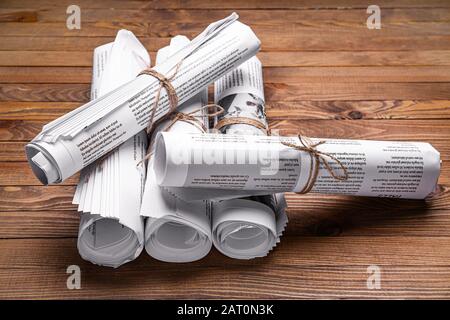 Many newspapers on wooden background Stock Photo