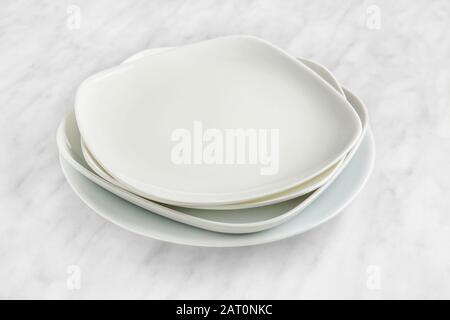 Stack of plates on light background Stock Photo