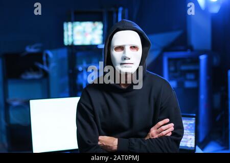 Professional hacker in mask indoors Stock Photo