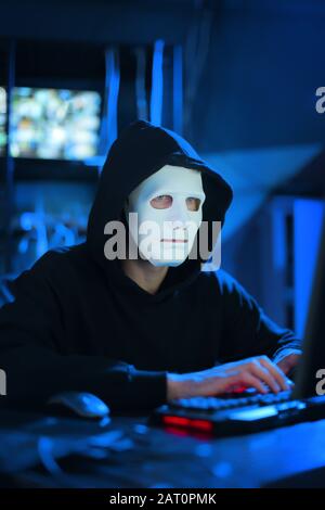 Professional hacker using computer in dark room Stock Photo